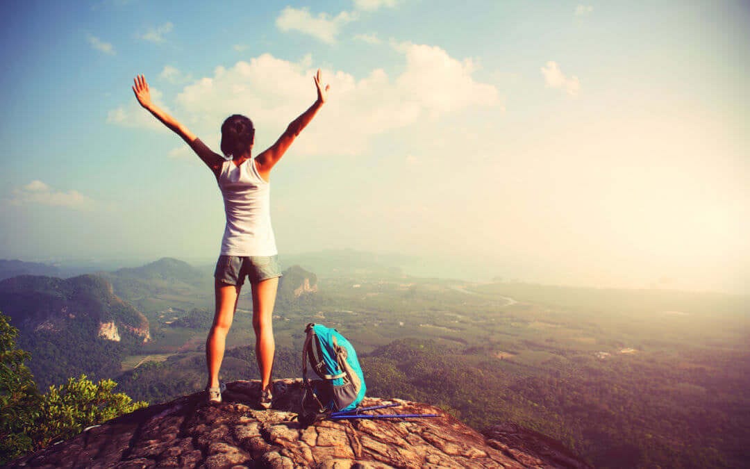 woman hiker enjoy the view on mountain peak cliff