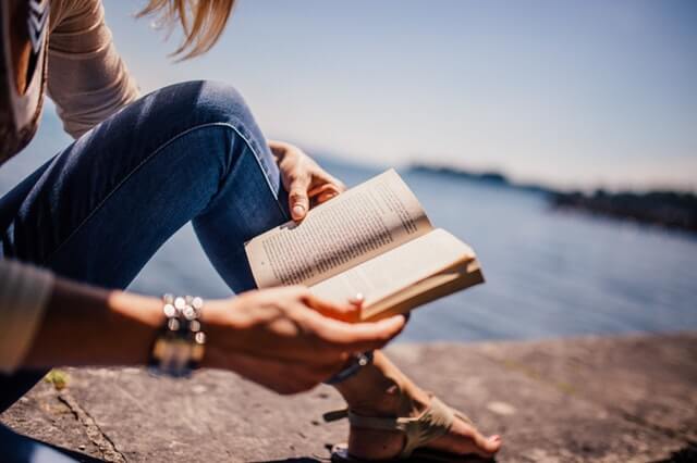 Woman Reading a Book in the Sea